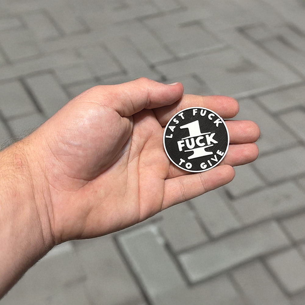 Last Fuck to Give novelty coin held in a hand