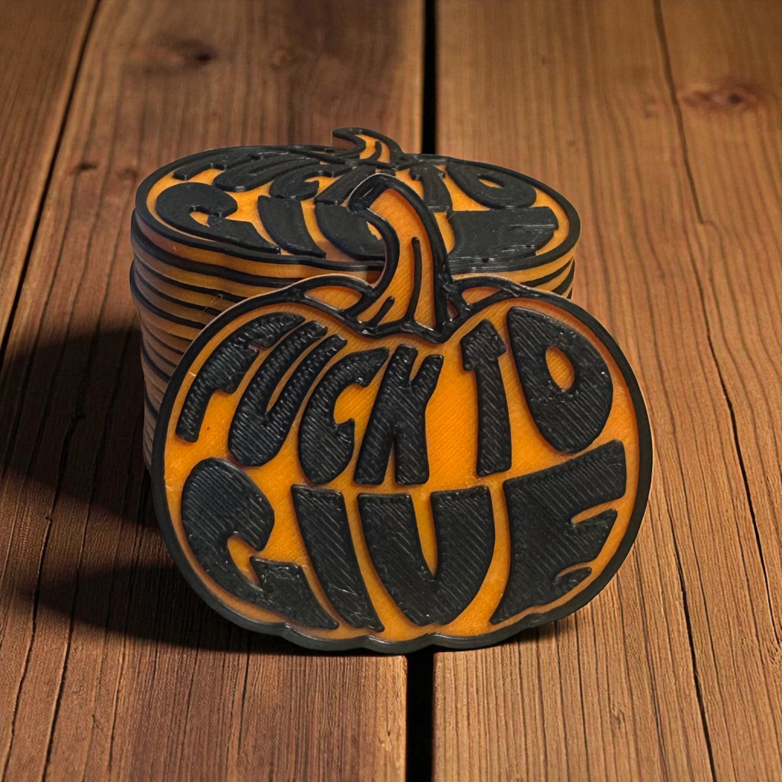 Stack of orange and black novelty pumpkin tokens